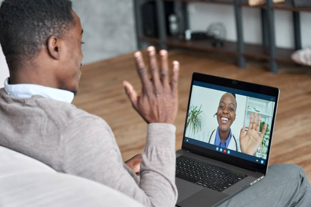 Virtual therapist consulting young man during online appointment on laptop at home. Telemedicine chat, telehealth meeting