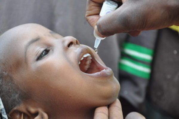 A drop of vaccine in a child's mouth