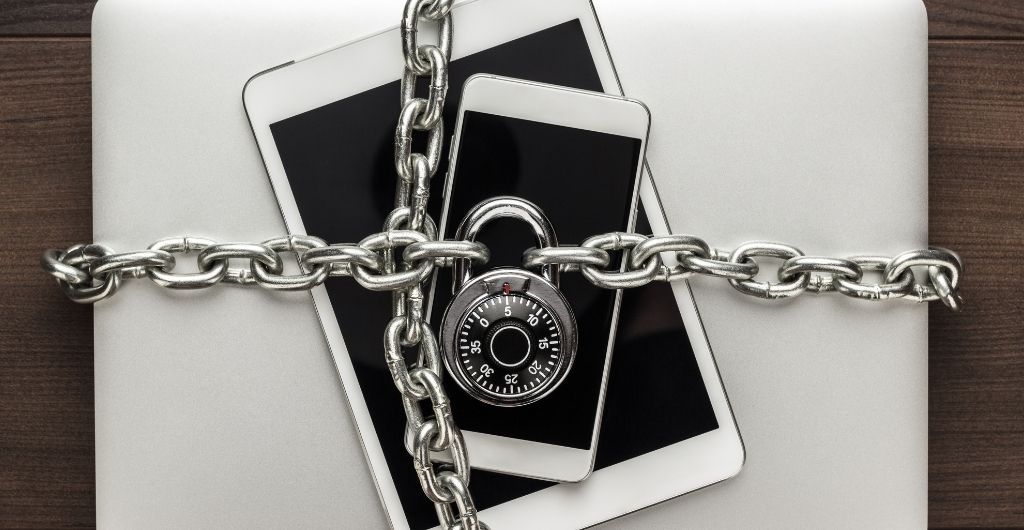 A phone and a tablet in a  locked chain.