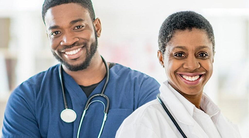 Two black doctors (Male and Female) smiling