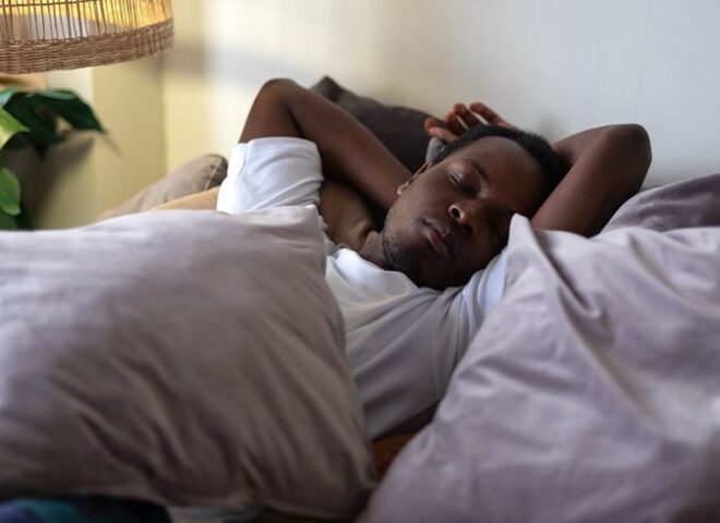 Black man sleeping in bed