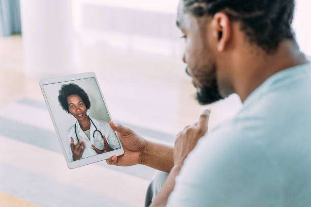 online telemedicine concept. Shot of a black man speaking to a black doctor using a digital tablet.